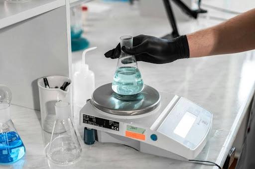 Laboratory analytical balance with sample on weighing pan